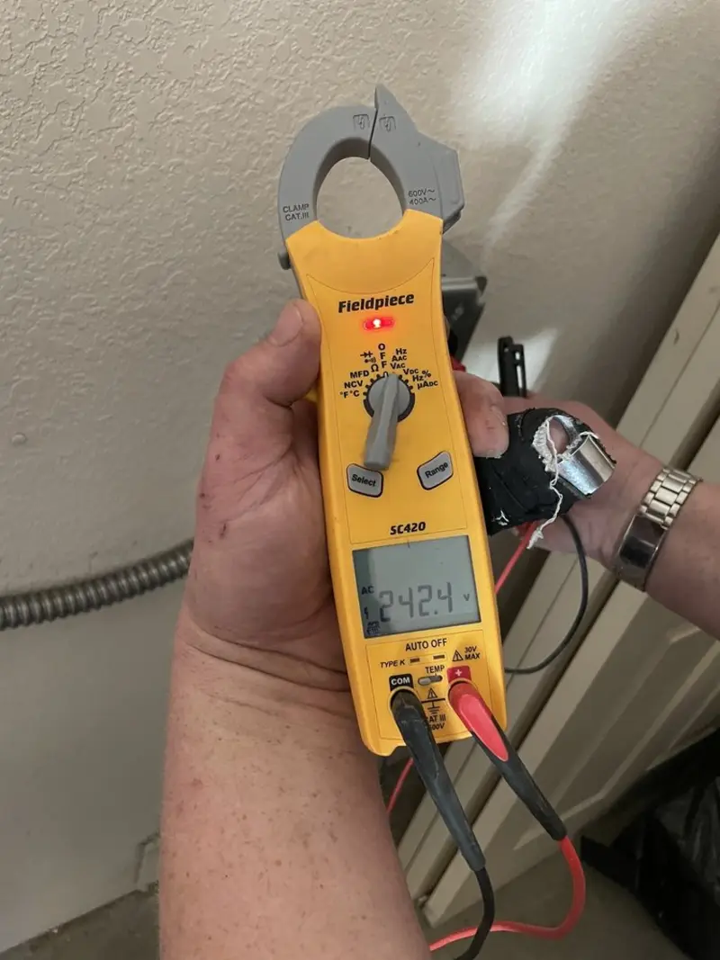 Voltage testing with clamp meter during Ceiling Fan Installation in Bridgetown